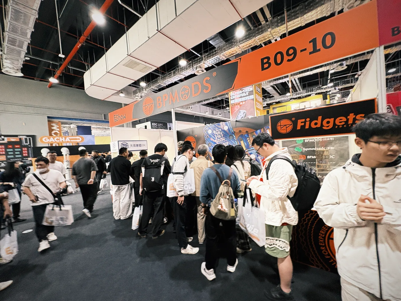 Crowds moving between booths on the EDC DAY 2026 show floor in Guangzhou
