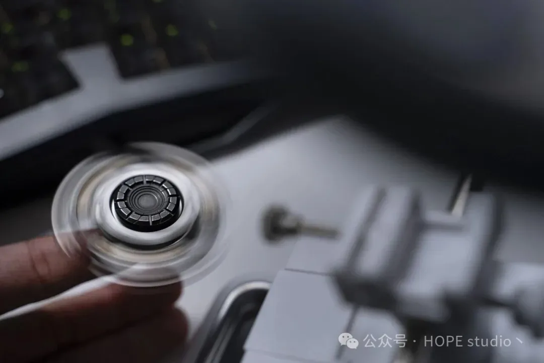 Hope Studio Blue Bird mid-spin in a hand, wings blurred into a disc