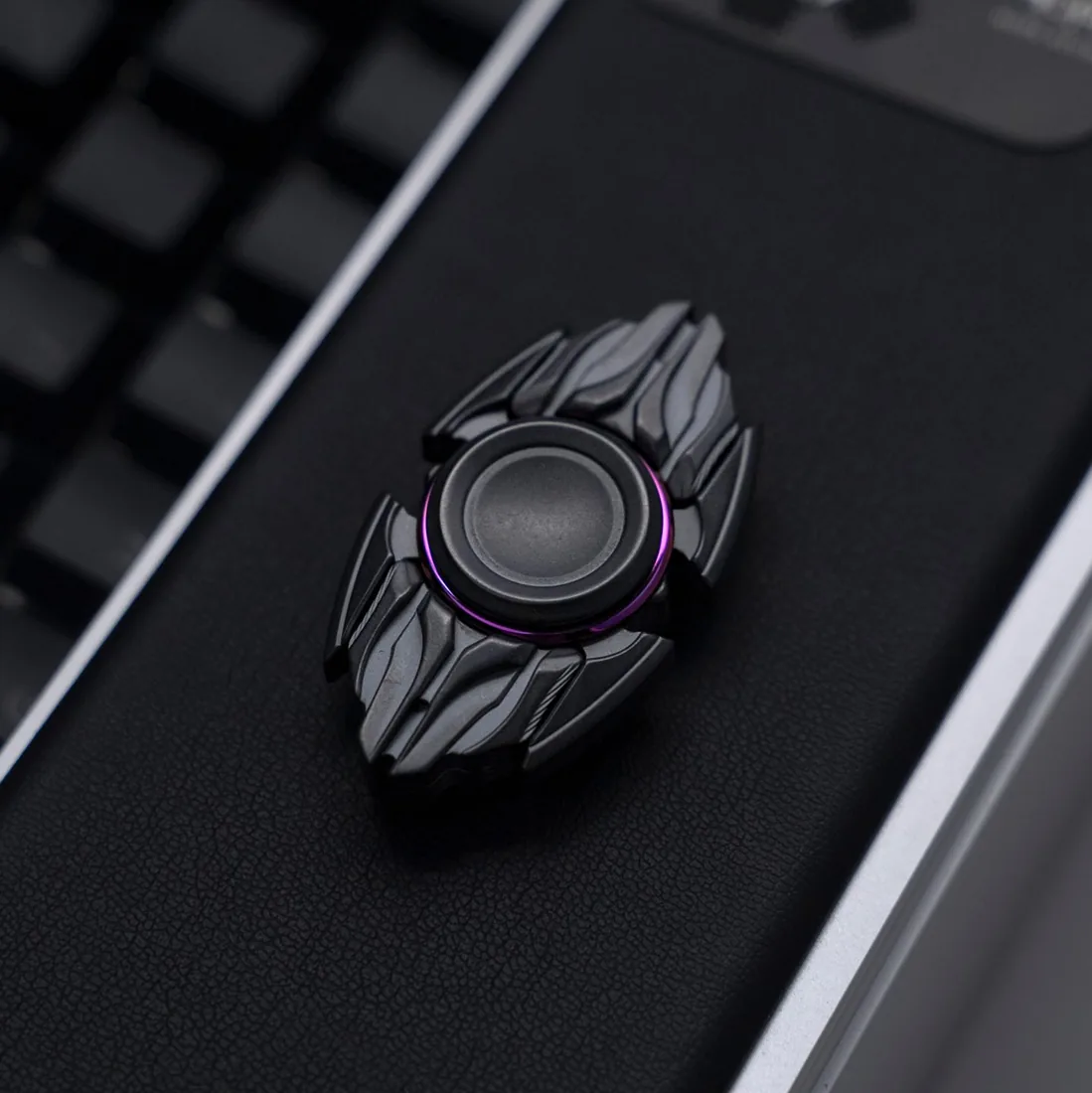 Hope Studio Dark Spinner, black wings around a bearing, on dark leather