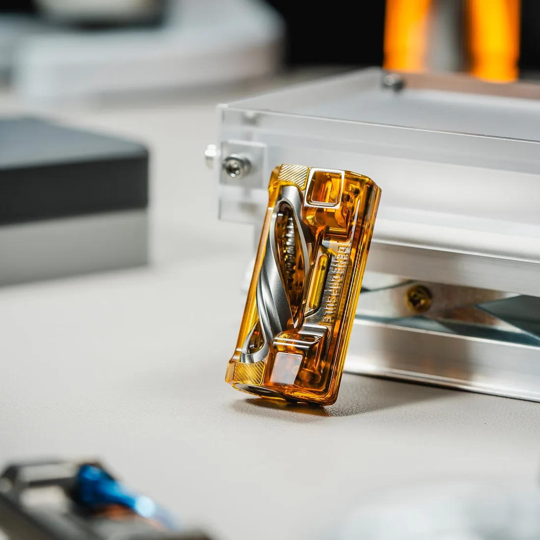 An amber 01EDC Gene Capsule slider standing on a machined rail